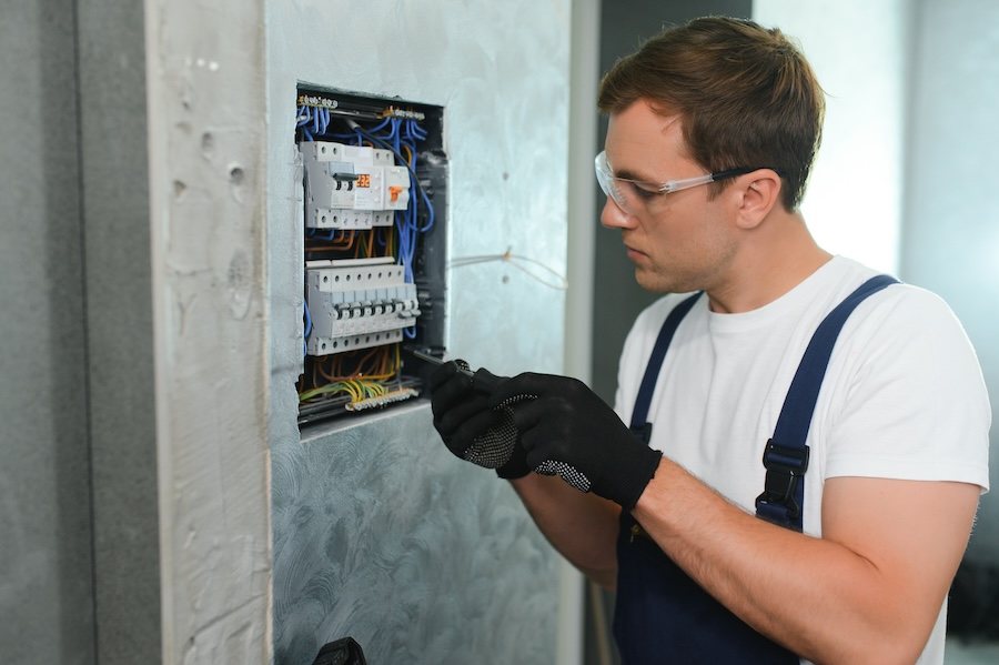 a male electrician works in a switchboard with an 2026 01 08 07 15 40 utc